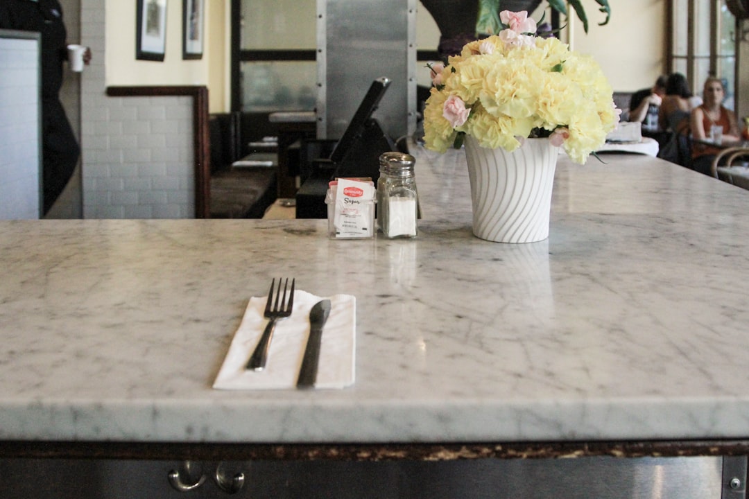 A worn kitchen countertop being measured for replacement in Lakewood